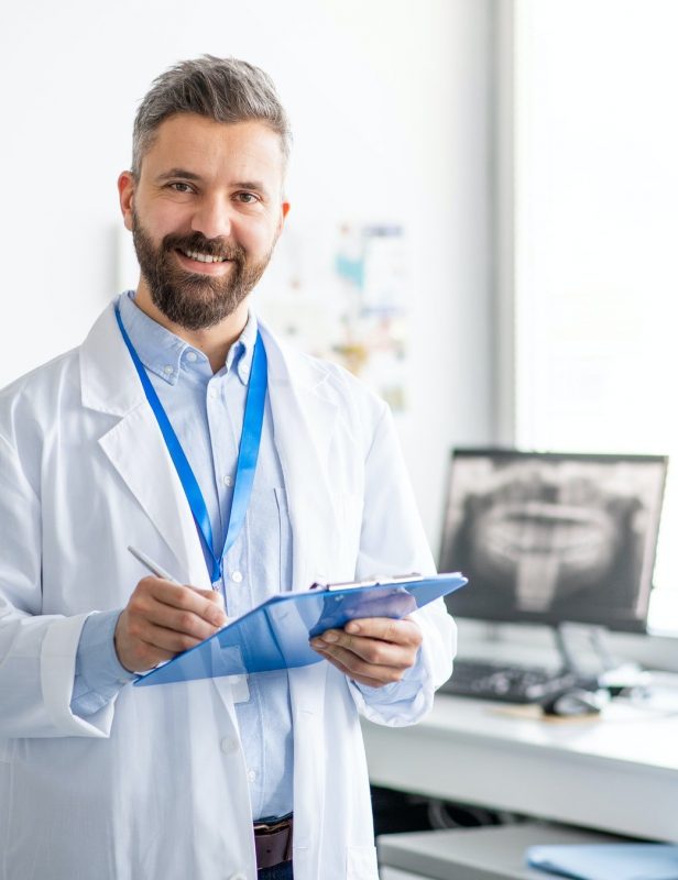 mature-dentist-in-modern-dental-surgery-looking-at-camera.jpg